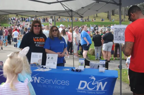 DSC_0079.webp DON Services booth at outdoor event promoting disability options network.